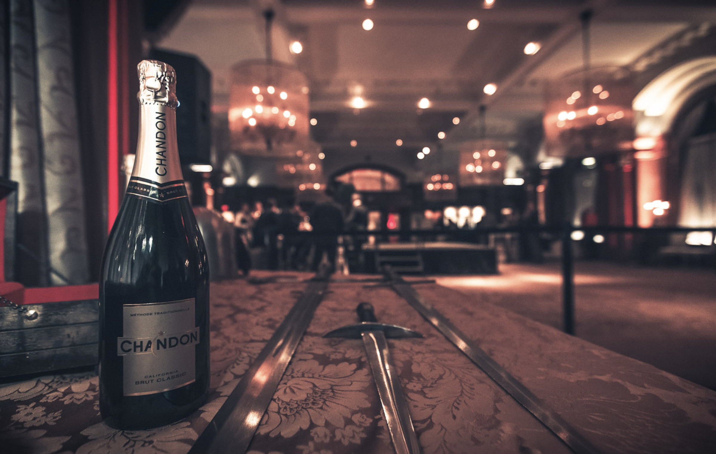 Swords laid out beside a bottle of champagne